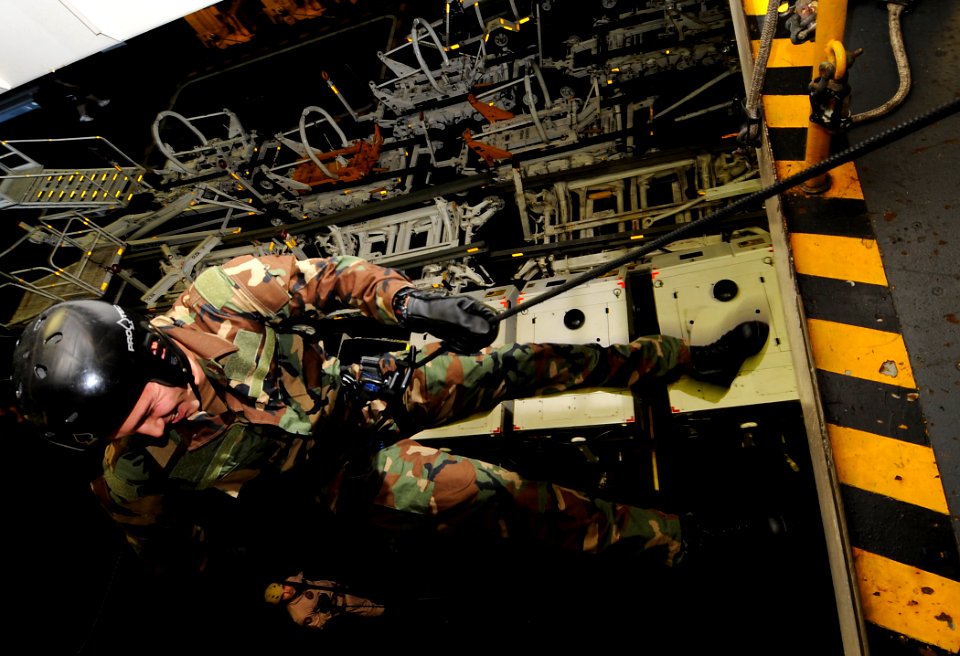 US Navy 100617-N-7317W-015 Explosive Ordnance Disposal Technician 3rd Class Peter Johal practices repelling in the hangar bay of the aircraft carrier USS Harry S. Truman (CVN 75)