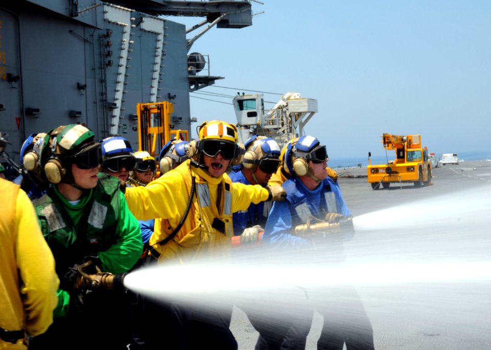 US Navy 100621-N-7908T-245 Air department Sailors assigned to the crash and salvage division of the aircraft carrier USS George H.W. Bush (CVN 77) perform hose sweeping movements during a flight deck firefighting drill
