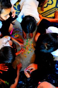 US Navy 100620-N-6597H-142 Lt. Derrick Horne helps Cambodian children put a puzzle together during a Pacific Partnership 2010 community service event at the Enfants du Cambodge orphanage