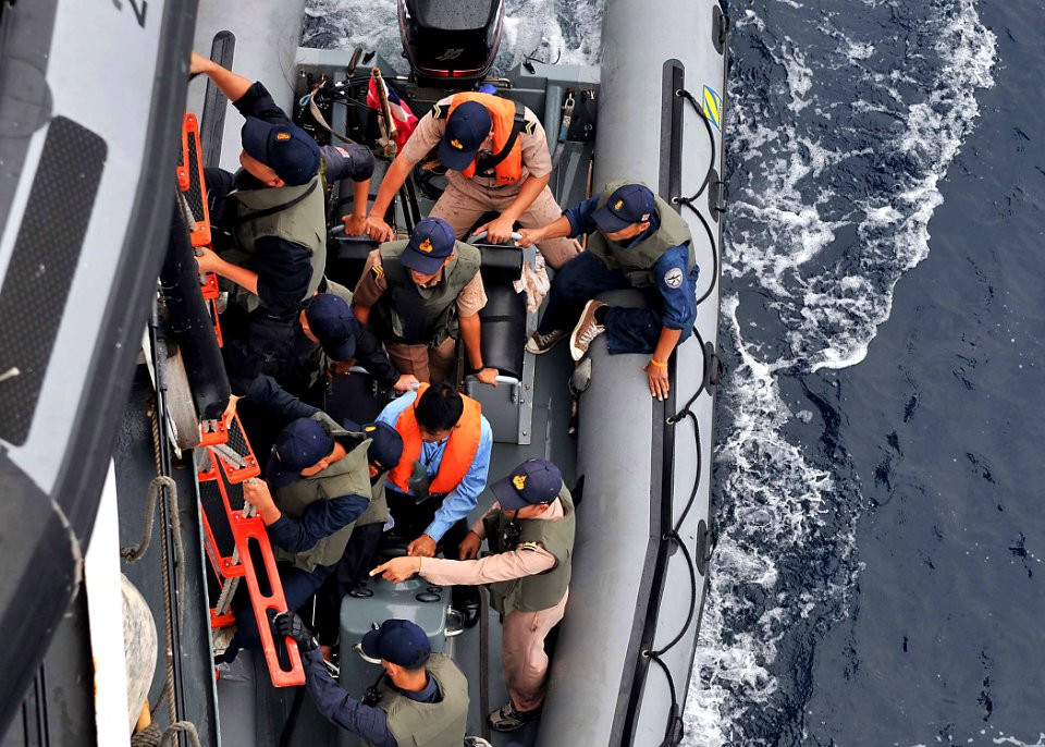 US Navy 100621-N-7643B-169 Royal Thai Navy sailors climb a rope ladder from a Zodiac small boat during a visit, board, search and seizure exercise