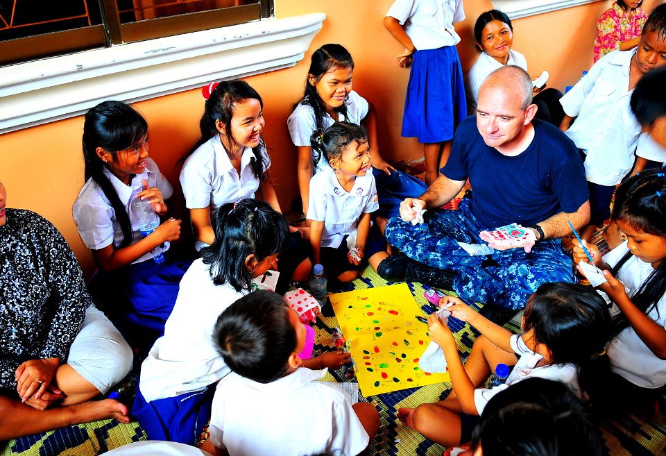 US Navy 100620-N-6597H-943 Lt. Derrick Horne finger-paints with Cambodian children during a Pacific Partnership 2010 community service event at the Enfants du Cambodge orphanage in Sihanoukville, Cambodia