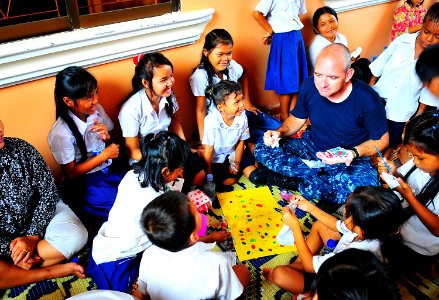 US Navy 100620-N-6597H-943 Lt. Derrick Horne finger-paints with Cambodian children during a Pacific Partnership 2010 community service event at the Enfants du Cambodge orphanage in Sihanoukville, Cambodia