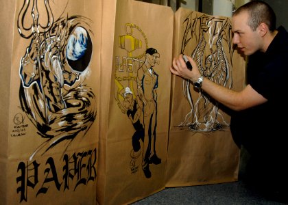 US Navy 100619-N-3705H-026 Aviation Electronics Technician Airman Reuben Troyer draws an artistic flare on trash bags aboard USS Harry S. Truman (CVN 75)
