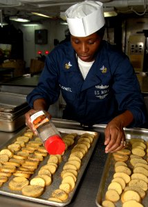 US Navy 100622-N-3705H-081 Machinist's Mate 1st Class Audrey McDaniel seasons potatoes for a Caribbean meal aboard the aircraft carrier USS Harry S Truman (CVN 75)