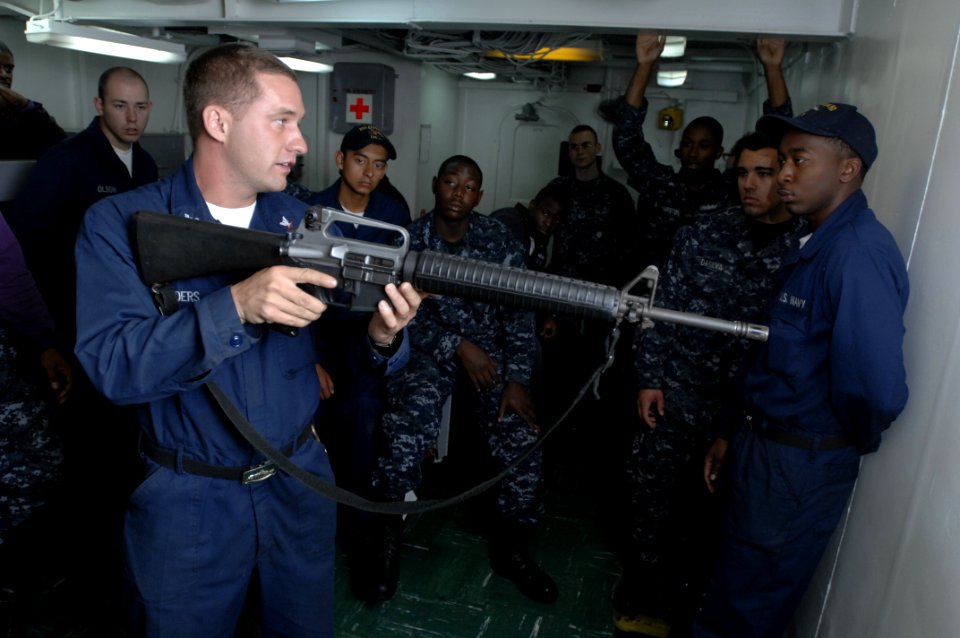US Navy 100619-N-6477M-024 Gunner's Mate 3rd Class Seth Childers conducts weapons familiarization training with an M-16 riffle aboard USS Cleveland (LPD 7)
