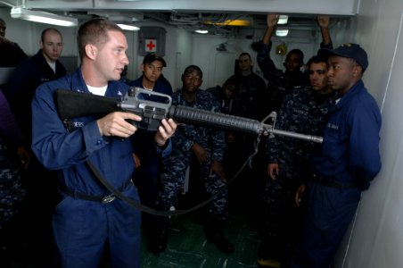 US Navy 100619-N-6477M-024 Gunner's Mate 3rd Class Seth Childers conducts weapons familiarization training with an M-16 riffle aboard USS Cleveland (LPD 7)