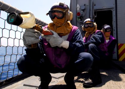 US Navy 100619-N-7638K-121 Sailors simulate the cooling of exploded ordnance from a helicopter crash during damage control training aboard USS Taylor (FFG 50)
