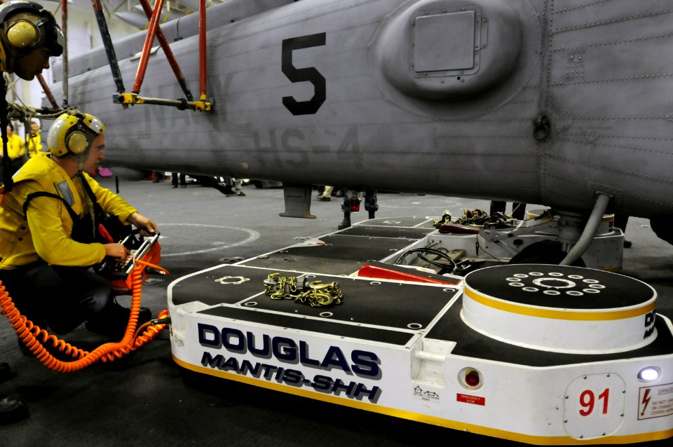 US Navy 100621-N-3659B-019 Aviation Boatswain's Mate (Handling) 3rd Class Dave Willsey operates the Mantis shipboard helicopter handler in the hangar bay of the aircraft carrier USS Ronald Reagan (CVN 76)