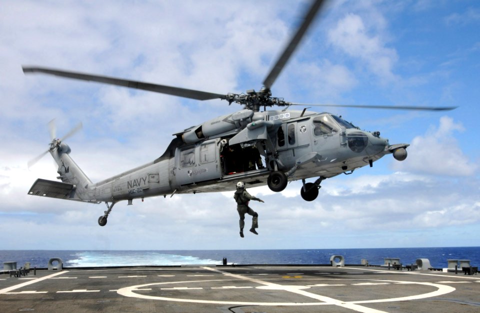 US Navy 100622-N-7058E-314 A naval aircrewman assigned to Helicopter Sea Combat Squadron (HSC) 22 is hoisted into an MH-60S Sea Hawk helicopter from the flight deck of the littoral combat ship USS Freedom (LCS 1)