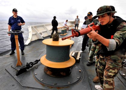 US Navy 100621-N-7643B-038 Chief Gunners Mate David Neal, assigned to the U.S. Coast Guard Cutter Mellon (WHEC 717), watches Royal Thai Navy sailors searching Mellon during a visit, board, search and seizure exercise