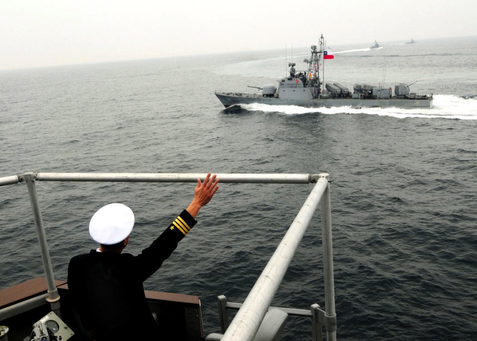 US Navy 100619-N-9301W-619 Cmdr. Scott Smith, commanding officer of the guided-missile frigate USS Klakring (FFG 42), waves as the Chilean navy fast attack craft Serrano (LM 38) passes by after Klakring rendered honors to Chile