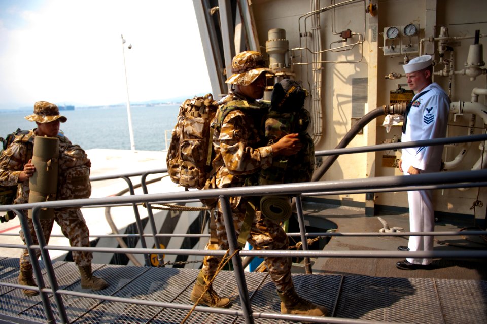 US Navy 100620-N-5319A-039 Officer of the Deck Aviation Boatswain's Mate (Fuel) 1st Class Timothy Scheanwald watches Mexican marines board the amphibious transport dock ship USS New Orleans (LPD 18)