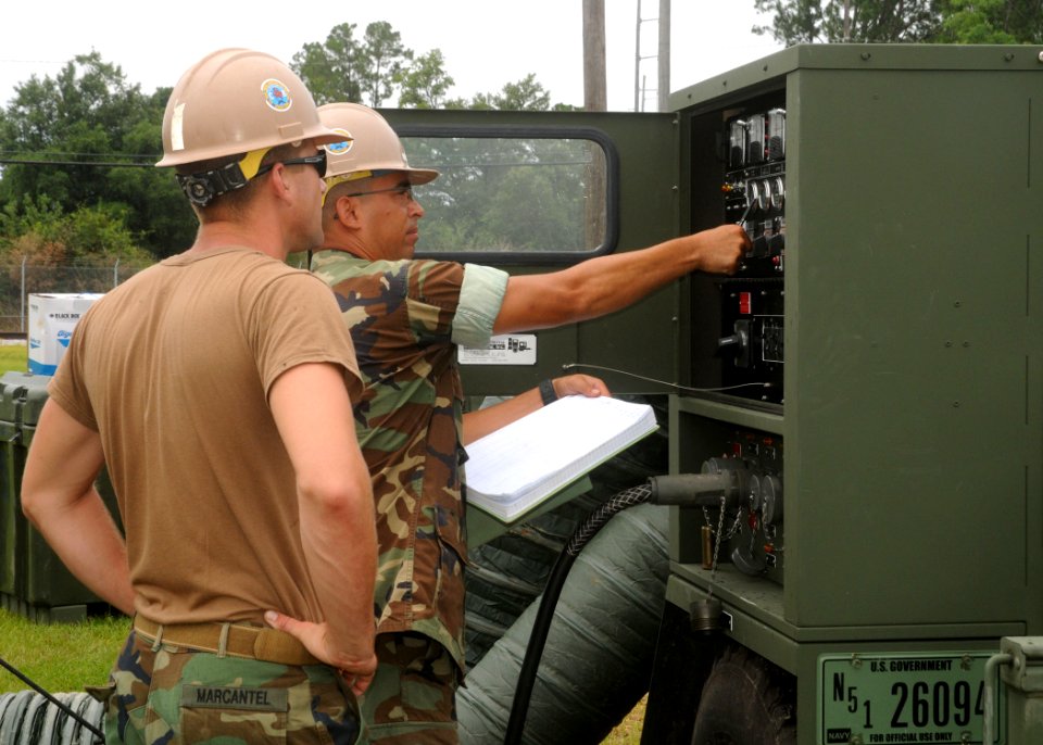 US Navy 100622-N-9564W-075 Construction Electrician 2nd Class Edward Hutton, right, and Construction Electrician 3rd Class Jordan Marcantel, both assigned to Bravo Company of Naval Mobile Construction Battalion (NMCB) 74