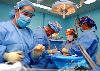 US Navy 100620-N-4044H-116 Hospital Corpsman 3rd Class Dana Doody loads a suture for surgeons during a surgery aboard the Military Sealift Command hospital ship USNS Mercy (T-AH 19)