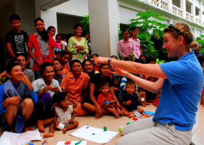 US Navy 100623-N-4044H-056 Georgia Ferris, a member of Latter-day Saint Charities, plays a game with children and adults during a community service event at the Enfants du Cambodge orphanage in Sihanoukville, Cambodia photo