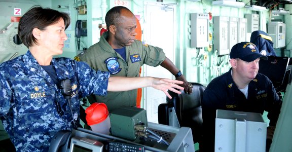 US Navy 100623-N-7058E-281 Cmdr. Kris Doyle, commanding officer of the littoral combat ship USS Freedom (LCS 1), explains the readiness control officer console on Freedom's bridge to Rear Adm. Earl L. Gay
