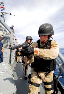 US Navy 100623-N-7638K-400 Yeoman 3rd Class Jeremy Tenney, assigned to the Oliver Hazard Perry-class frigate USS Taylor (FFG 50), acts as rear security after a visit, board, search and seizure team