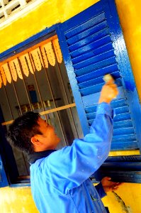 US Navy 100621-N-6410J-057 A Sailor from the Japan Maritime Self-Defense Force amphibious ship USS Kunisaki (LST 4003) paints Ohtres Chas Primary School during a Pacific Partnership 2010 community service event