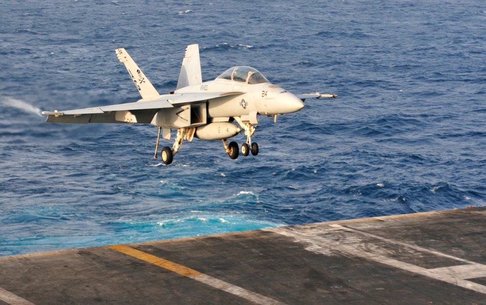 US Navy 100621-N-3595W-001 An F-A-18F Super Hornet assigned to the Jolly Rogers of Strike Fighter Squadron (VFA) 103, lands aboard the aircraft carrier USS Dwight D. Eisenhower (CVN 69)