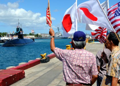 US Navy 100621-N-8539M-595 Onlookers wave as the Japan Maritime Self-Defense Force Oyashio-class submarine J.S. Mochishio (SS 600) arrives at Joint Base Pearl Harbor-Hickam to support Rim of the Pacific (RIMPAC) exercises