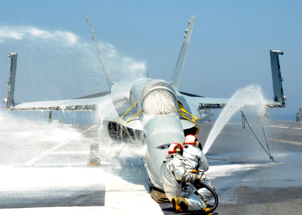 US Navy 100621-N-7908T-029 Air department Sailors assigned to the crash and salvage division of the aircraft carrier USS George H.W. Bush (CVN 77) spray water on an F-A-18 Hornet training aircraft