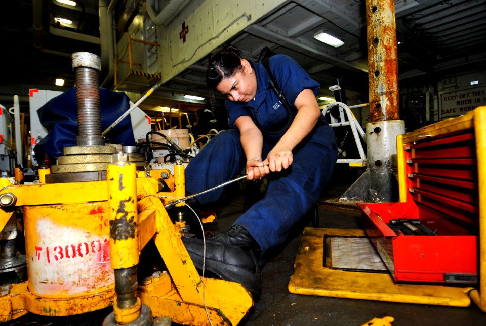 US Navy 100624-N-6003P-029 Aviation Support Equipment Technician Airman Alessandra Muniz performs maintenance on an aircraft jack pump aboard the aircraft carrier USS Harry S. Truman (CVN 75)
