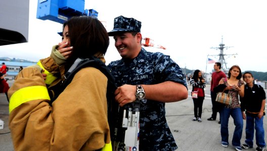 US Navy 100622-N-5716H-274 Machinist's Mate 3rd Class David Hyndman helps a guest aboard the U.S. 7th Fleet command ship USS Blue Ridge (LCC 19)