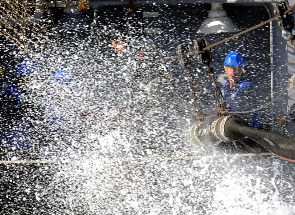 US Navy 100624-N-7605J-106 Sailors from the Ticonderoga-class guided-missile cruiser USS Chancellorsville (CG 62) prepare to attach a fuel hose from the aircraft carrier USS Ronald Reagan (CVN 76) during a fueling at sea