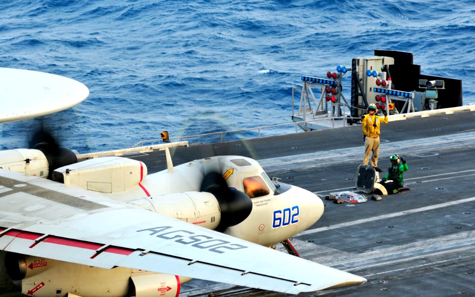 US Navy 100623-N-3595W-004 Sailors signal the pilot of an E-2C Hawkeye from the Bluetails of Carrier Airborne Early Warning Squadron (VAW) 121, as it prepares to take off from the aircraft carrier USS Dwight D. Eisenhower (CVN