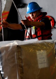 US Navy 100624-N-2013O-110 Boatswain's Mate Seaman Ivan Gonzalez, from San Bernadino, Calif., slings pallets aboard the aircraft carrier USS George Washington (CVN 73)