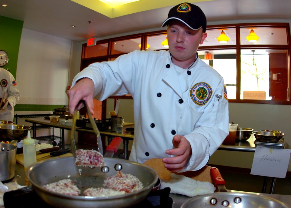 US Navy 100624-N-8132M-151 Culinary Specialist 2nd Class Brian Meilicke, representing Commander, Navy Region Northwest, prepares a three-course meal during the 2nd annual Culinary Competition, sponsored by Commander, Navy Insta
