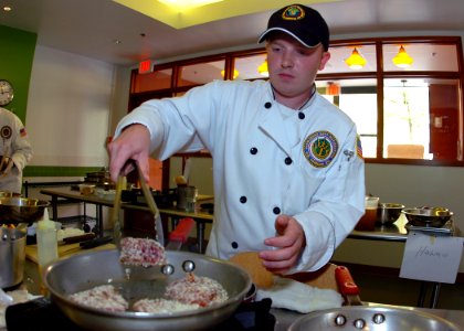 US Navy 100624-N-8132M-151 Culinary Specialist 2nd Class Brian Meilicke, representing Commander, Navy Region Northwest, prepares a three-course meal during the 2nd annual Culinary Competition, sponsored by Commander, Navy Insta