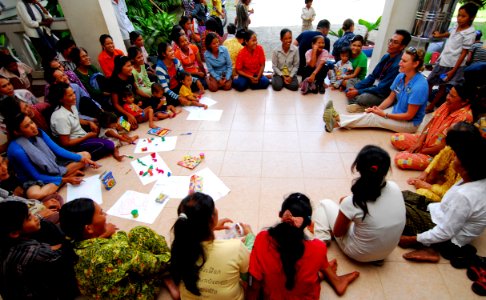 US Navy 100623-N-4044H-075 Georgia Ferris, a member of Latter-day Saint Charities, plays a game with children and adults during a community service event at the Enfants du Cambodge orphanage in Sihanoukville, Cambodia photo