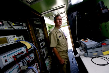 US Navy 100622-N-8863V-415 ear Adm. James J. Shannon, commander of the Naval Surface Warfare Center, inspects the interior of the Expeditionary Test and Measurement System container during a visit to Naval Surface Warfare Cente photo