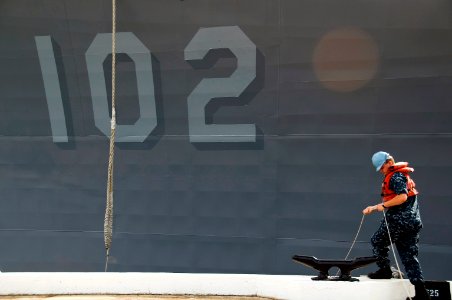 US Navy 100624-N-6674H-004 A sailor helps moor in the Arleigh Burke-class guided-missile destroyer USS Sampson (DDG 102) as the ship arrives at Joint Base Pearl Harbor-Hickam