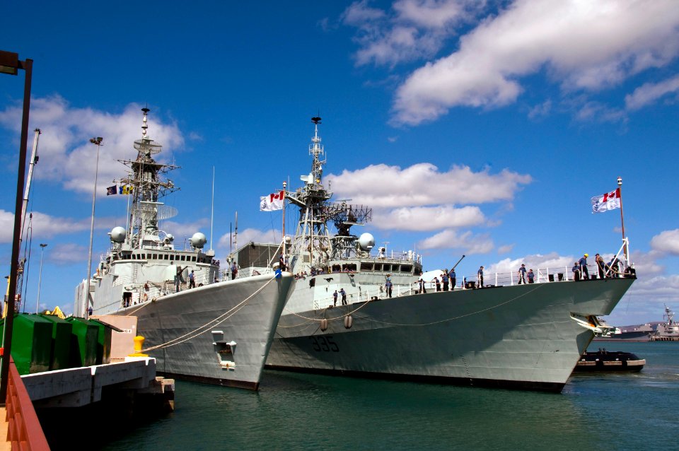 US Navy 100624-N-6674H-015 Sailors aboard the Canadian Navy Halifax-class frigate HMCS Calgary (FFH 335) moor the ship next the Iroquois-class guided-missile destroyer HMCS Algonquin (DDG 283)