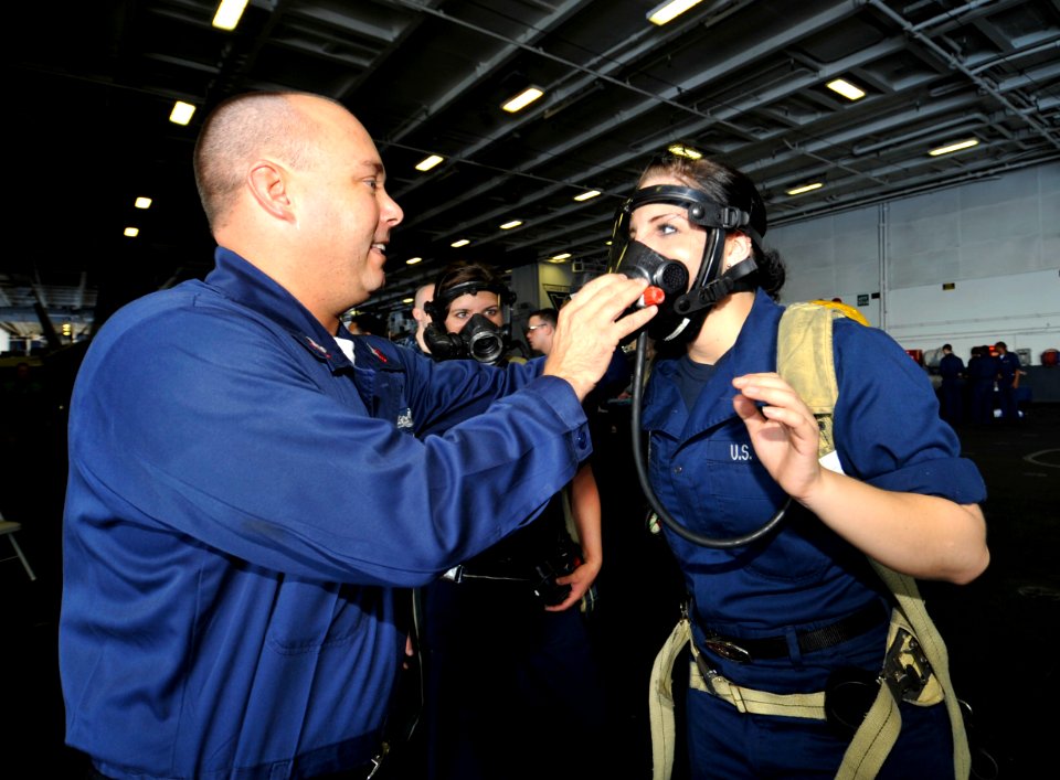 US Navy 100625-N-6003P-036 Aviation Ordnanceman Airman Tracy Sicura tries on a Self-Contained Breathing Apparatus