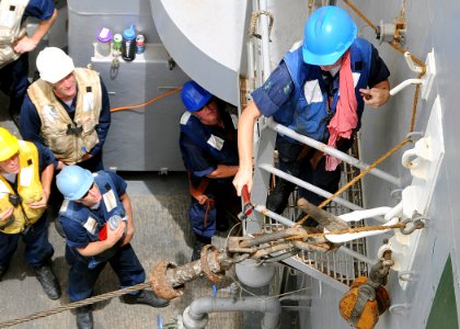 US Navy 100626-N-1082Z-026 Boatswain's Mate 2nd Class Nicole K. Toepfer, from Newburgh, N.Y., trips the pelican hook to release the out hall wire during an emergency breakaway dril
