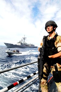US Navy 100623-N-7638K-534 Ensign Bryan Kline, from Papillion, Neb. assigned to the Oliver Hazard Perry-class frigate USS Taylor (FFG 50), stands ready as the rigid-hull inflatable boat approaches the Croatian coast guard vesse
