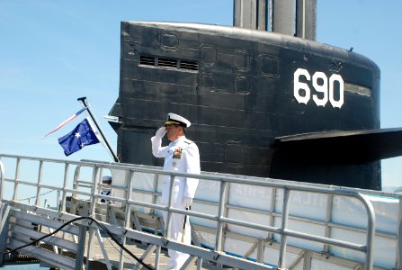 US Navy 100625-N-3090M-130 Rear Adm. Douglas McAneny, commander of Submarine Force, U.S. Pacific Fleet, salutes for the Admiral's March and 13-gun salute