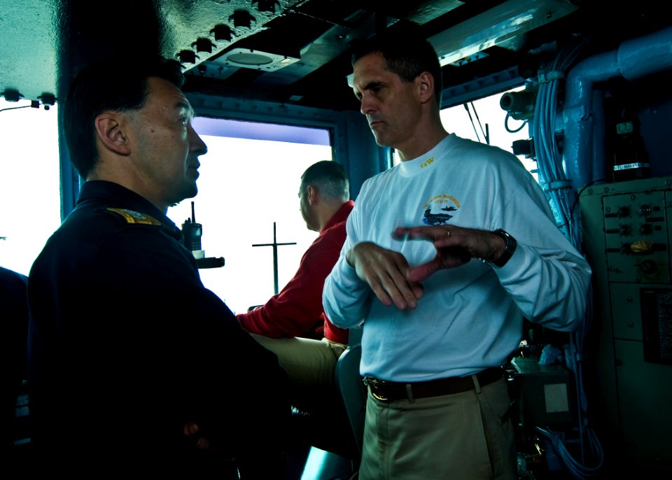 US Navy 100624-N-4830B-082 Capt. David Lausman, commanding officer of the aircraft carrier USS George Washington (CVN 73), explains emergency breakaway procedures to Japan Maritime Self-Defense Force Rear Adm. Umio Otsuka