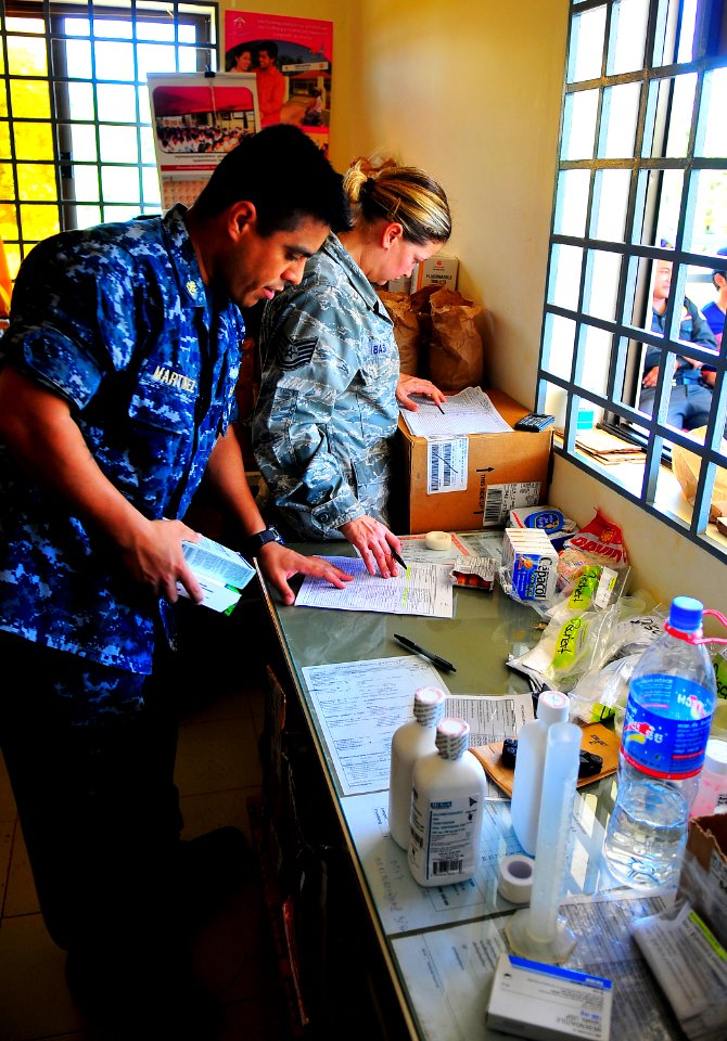 US Navy 100624-N-6597H-424 Chief Hospital Corpsman Carlos Martinez, left, and Tech. Sgt. Jill Bass, both assigned to the Military Sealift Command hospital ship USNS Mercy (T-AH 19)
