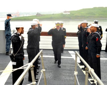 US Navy 100628-N-3548M-049 Chief of Naval Operations (CNO) Adm. Gary Roughead salutes Sailors from the guided-missile cruiser USS Gettysburg as he goes aboard to speak with Sailors and tour the ship photo