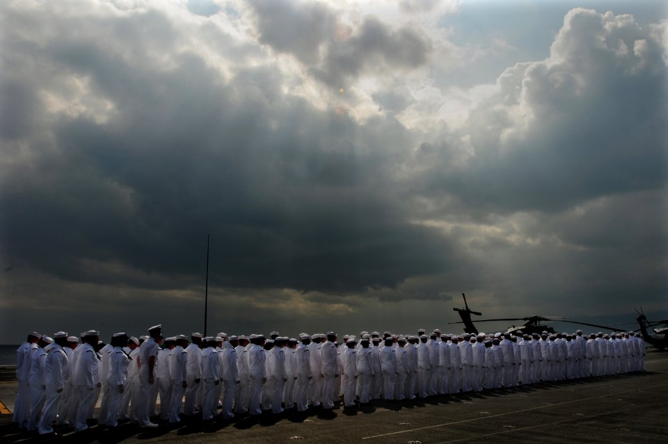 US Navy 100628-N-3659B-025 Sailors aboard the aircraft carrier USS Ronald Reagan (CVN 76) prepare to man the rails before the ship passes the USS Arizona memorial