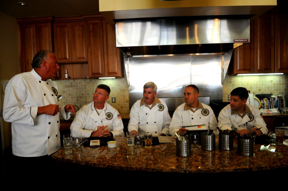US Navy 100624-N-9818V-091 Chef Guy Mitchell, left, joins senior leadership as judges t the Commander Navy Installations Command's 2nd annual Culinary Competition at CulinAerie