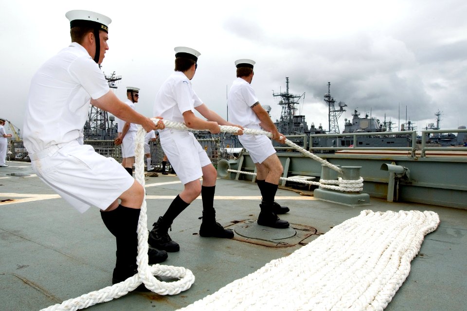 US Navy 100626-O-8247T-052 Sailors assigned to the Royal Australian Navy amphibious landing platform HMAS Kanimbla (L 51) handles the mooring line as the ship pulls into Pearl Harbor, Hawaii