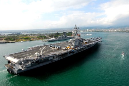 US Navy 100628-N-5684M-743 Sailors and Marines man the rails aboard the aircraft carrier USS Ronald Reagan (CVN 76) as it passes the USS Missouri and USS Arizona memorials in Pearl Harbor photo