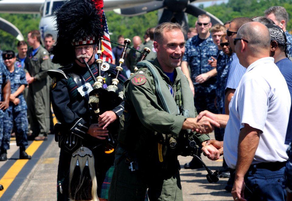 US Navy 100624-N-9712C-003 Cmdr. David Fritz is congratulated by squadron personnel after his final flight in an E-2C Hawkeye as commanding officer of Airborne Early Warning Squadron (VAW) 77