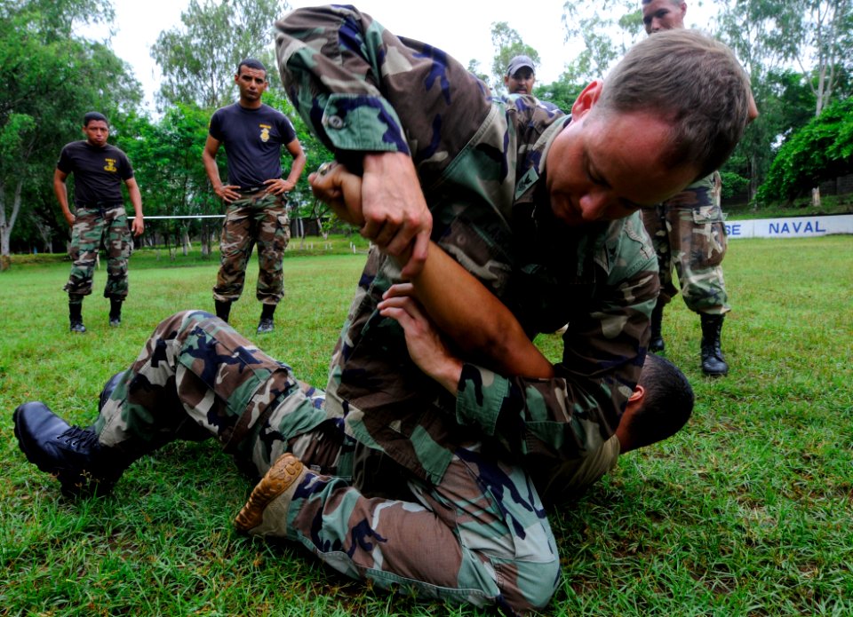 US Navy 100625-N-9643W-057 Equipment Operator 1st Class Daniel Lasich, from Rosenberg, Oregon, teaches a group of El Salvadorian sailors basic takedown techniques