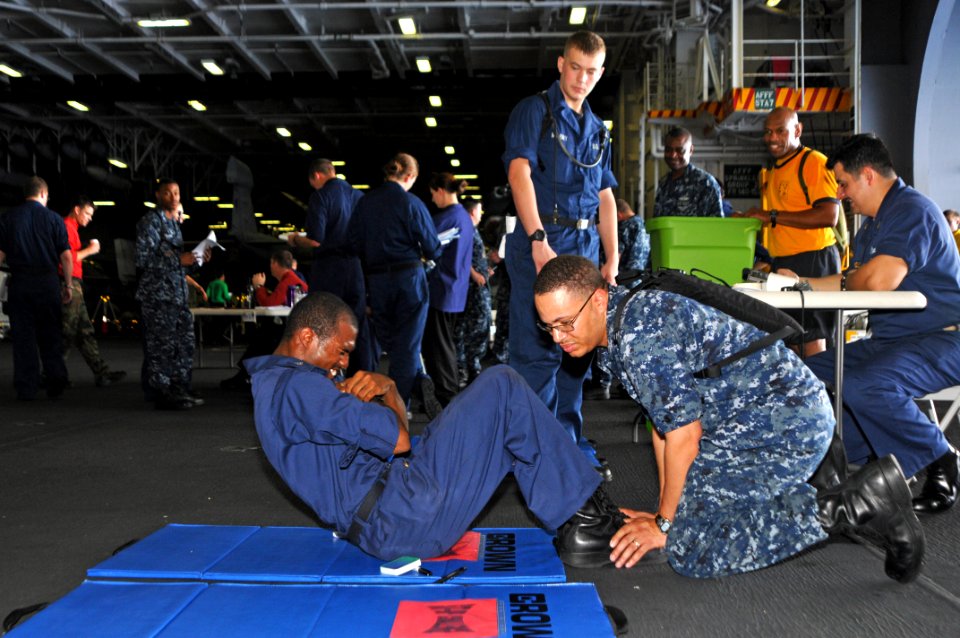 US Navy 100625-N-6362C-023 Logistics Specialist 3rd Class Christopher Glover completes 120 sit-ups in two minutes during a Mind, Body, and Spirit Campaign aboard the aircraft carrier USS Harry S. Truman (CVN 75)